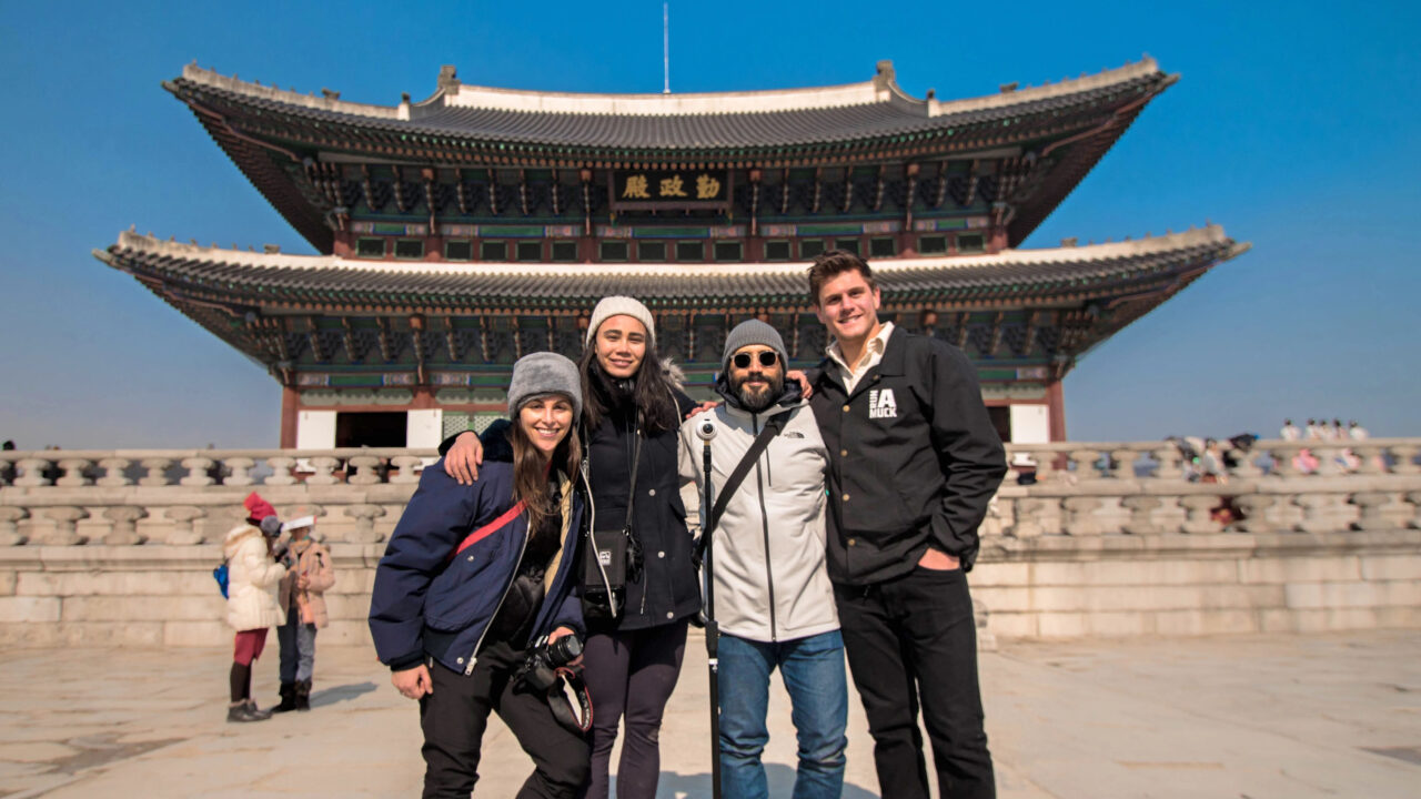 USC students on an overseas trip in South Korea, standing in front of a traditional building, representing the USC Korean Studies Institute