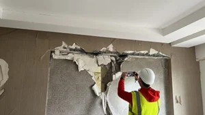 Dr. Gencturk investigating damage in a reinforced concrete beam between two shear walls.