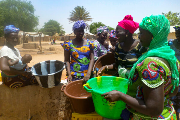 Gambian women socializing while collecting water