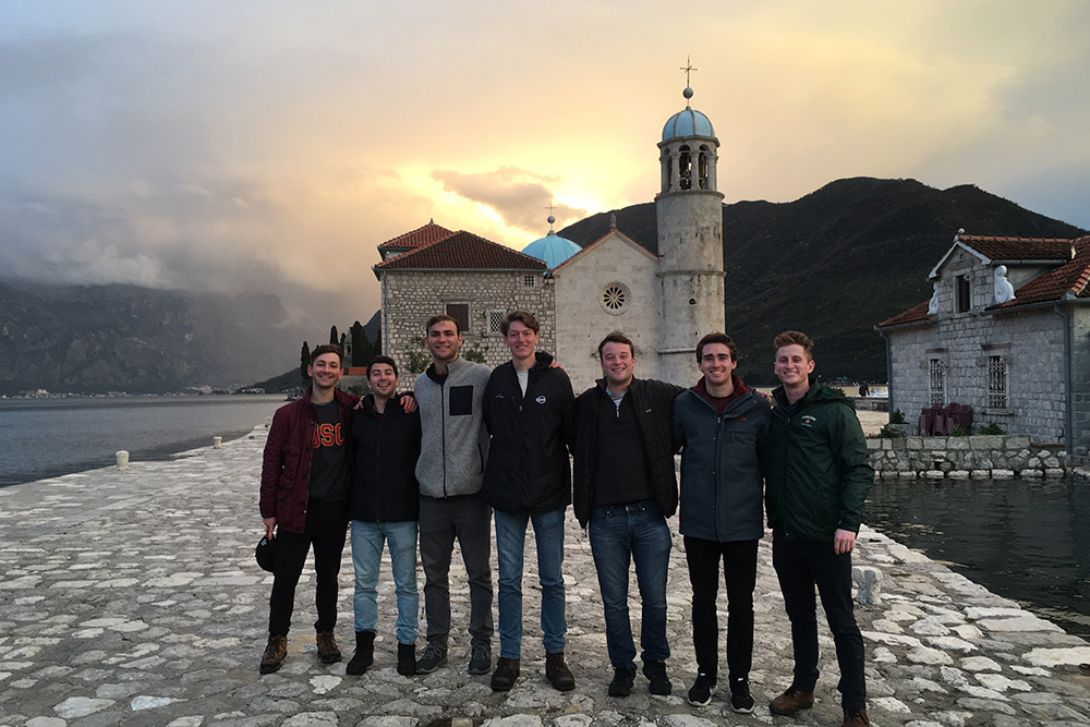 Group of USC students in front of the historical Church of Our Lady of the Rocks in Kotor, Montenegro during sunset, representing USC Student Travel Abroad