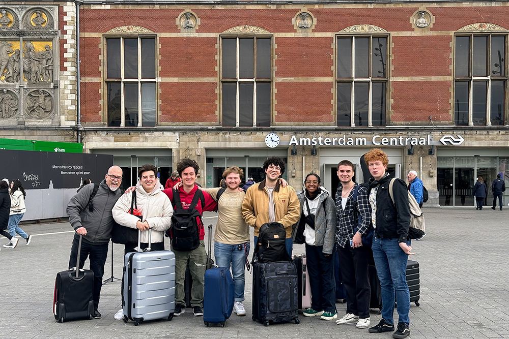 Music students with luggage at Amsterdam Central Station for USC Thornton School of Music exchange program.